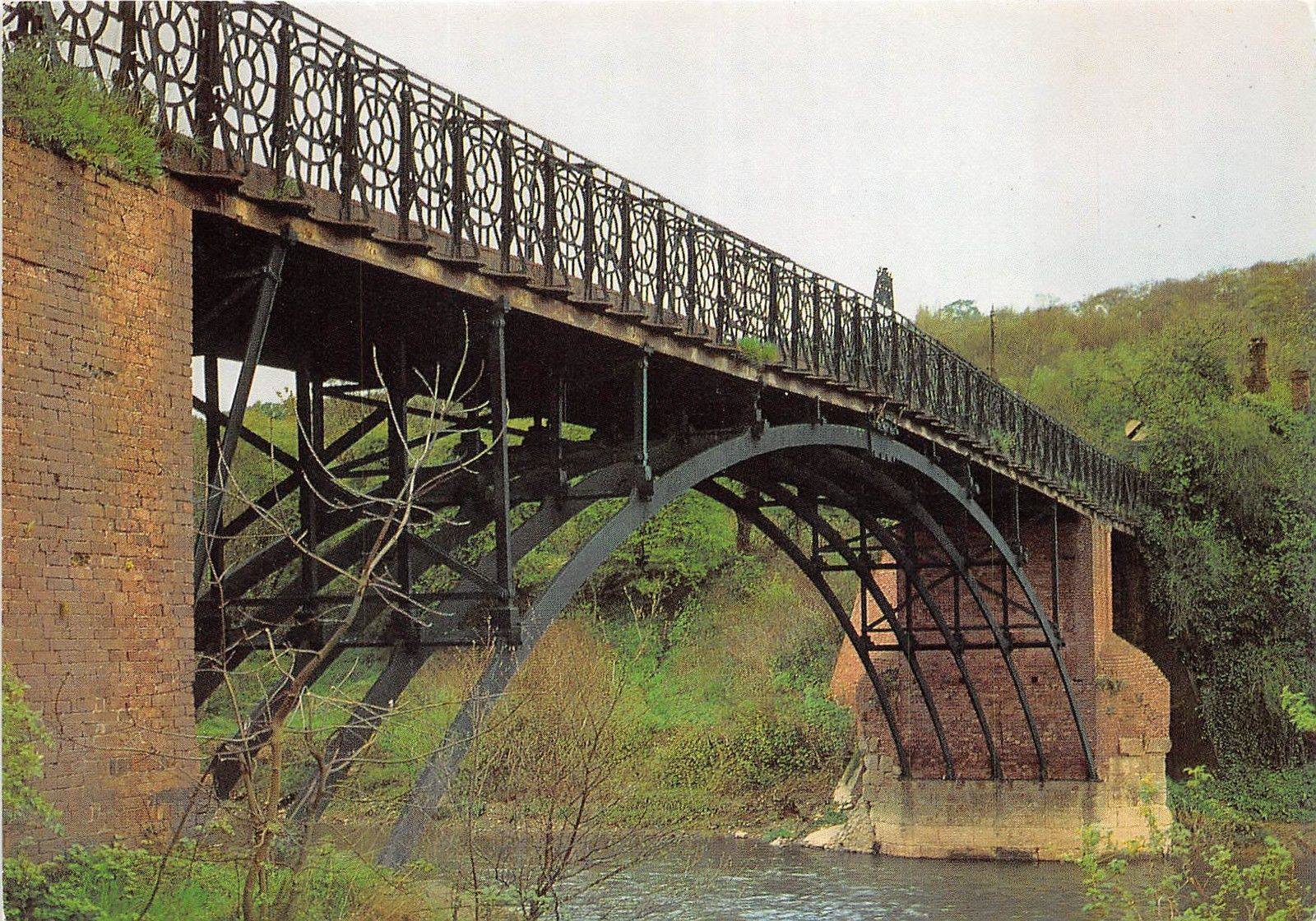 A colour photograph taken from the Broseley bank, looking up under the deck at the exposed ironwork. Study the patched and sprayed surfaces closely and you can trace three separate repair campaigns — 1961, 1969, and 2004–05 — each generation of engineers grappling anew with keeping this Georgian ironwork roadworthy.