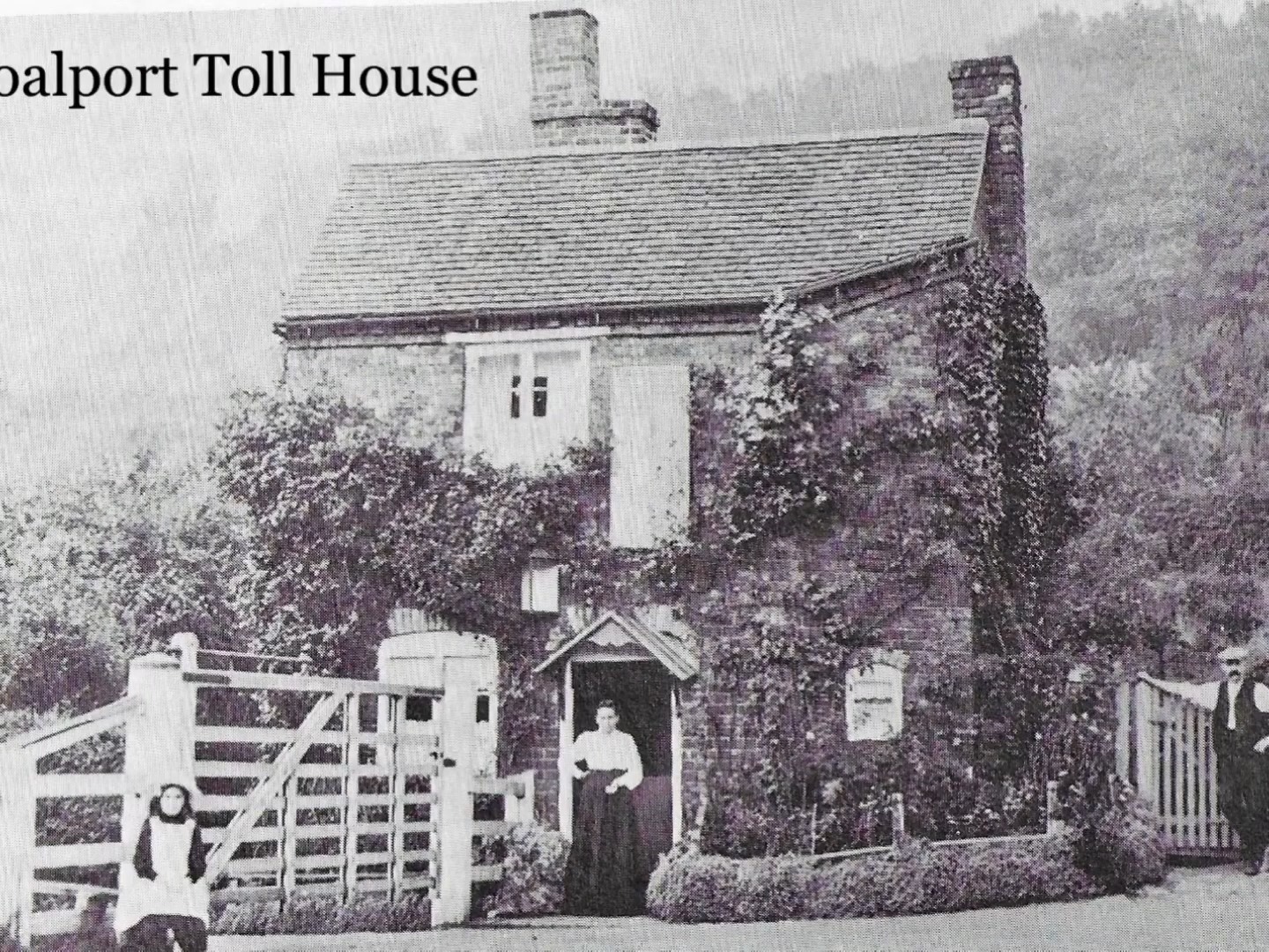 The Coalport Bridge Toll House, ivy-clad, with the keeper standing in the doorway around 1900. This modest building had already led several lives by then — a warehouse by 1793, a house by 1815, and a toll house from the 1818 rebuild — making it as much a family home as a place of work.