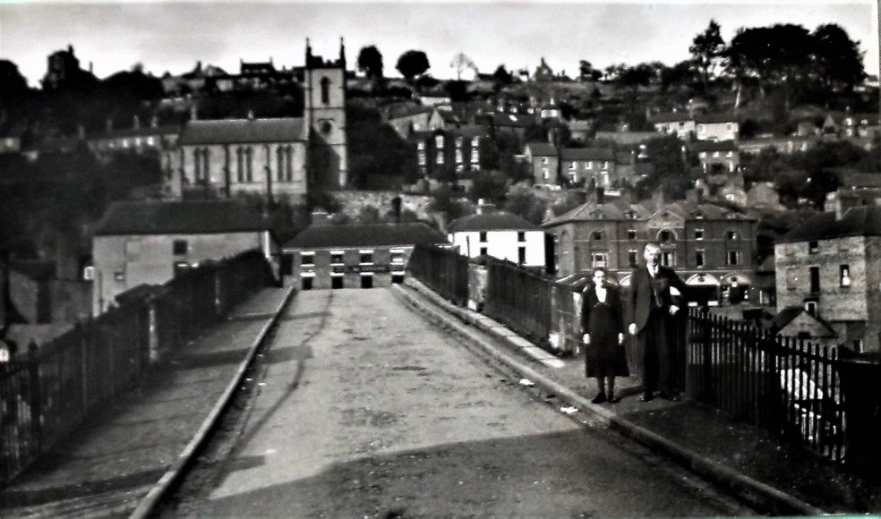 The Iron Bridge with toll keepers Mr and Mrs Cookson, around 1934.