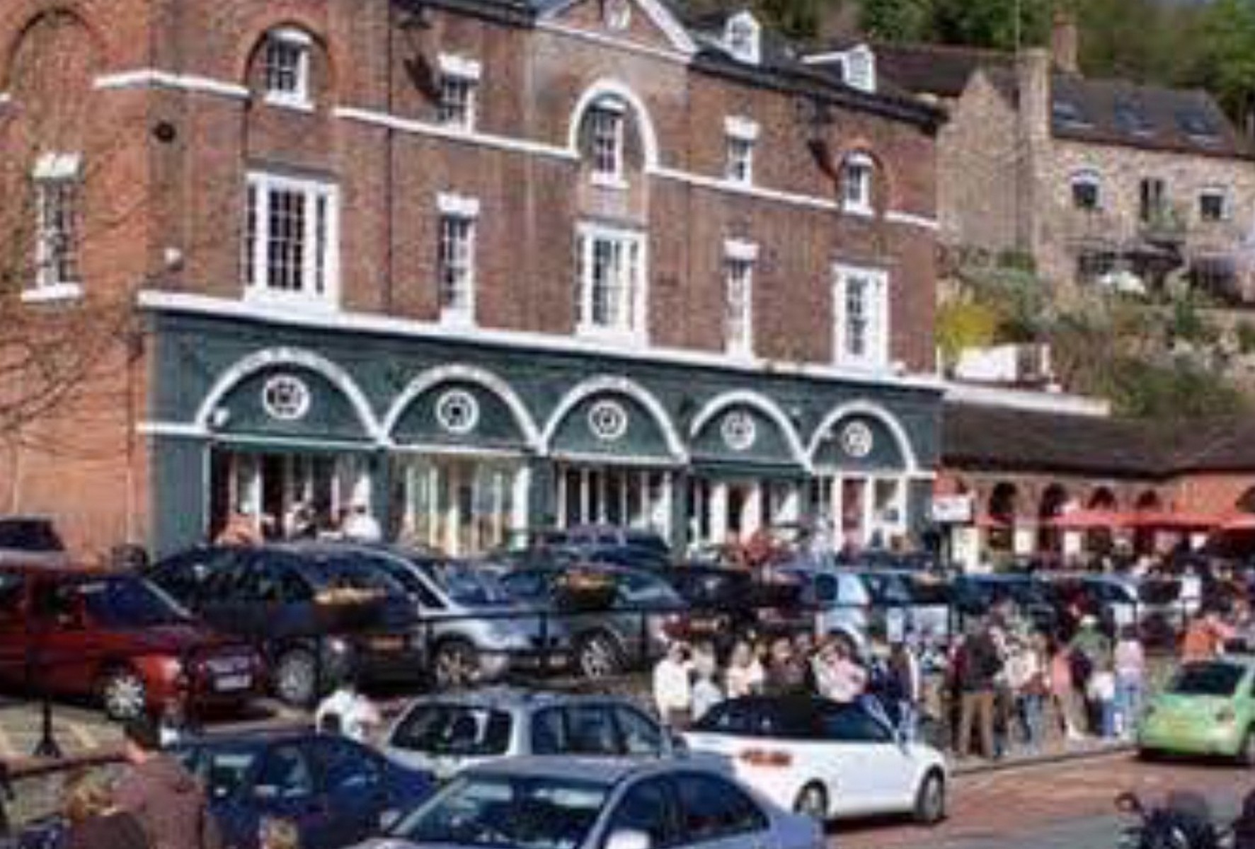 The arcade in green and white with the Square nose-to-tail with parked cars. There is barely a yard of clear ground in the picture, which is precisely the problem the 1975 conservation report set out to solve. Exact date unknown.
