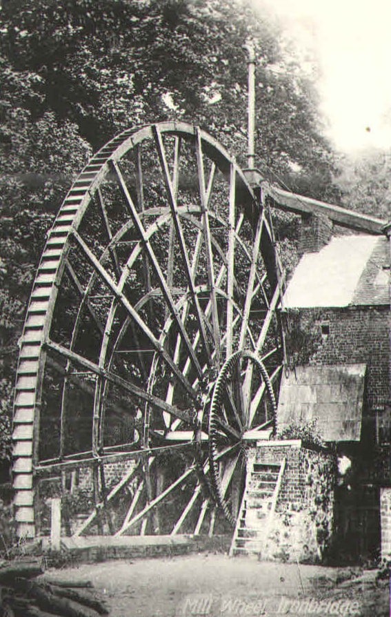 A postcard titled "Mill Wheel, Ironbridge", showing the wheel beside the mill building.