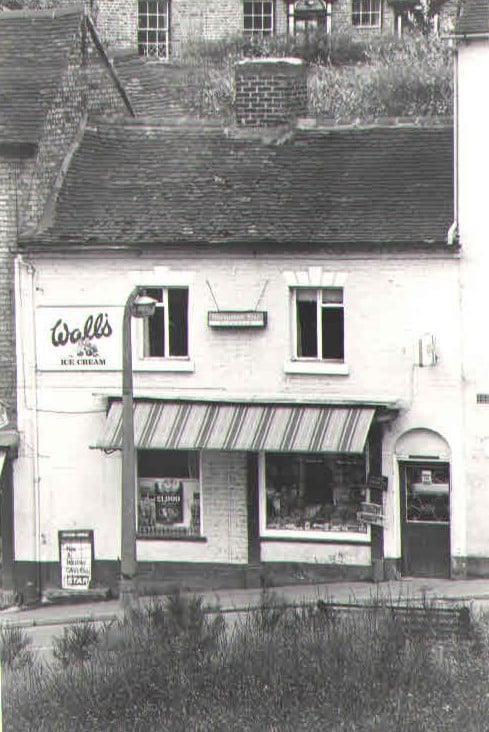 A striped awning and a Wall's Ice Cream sign on the hill