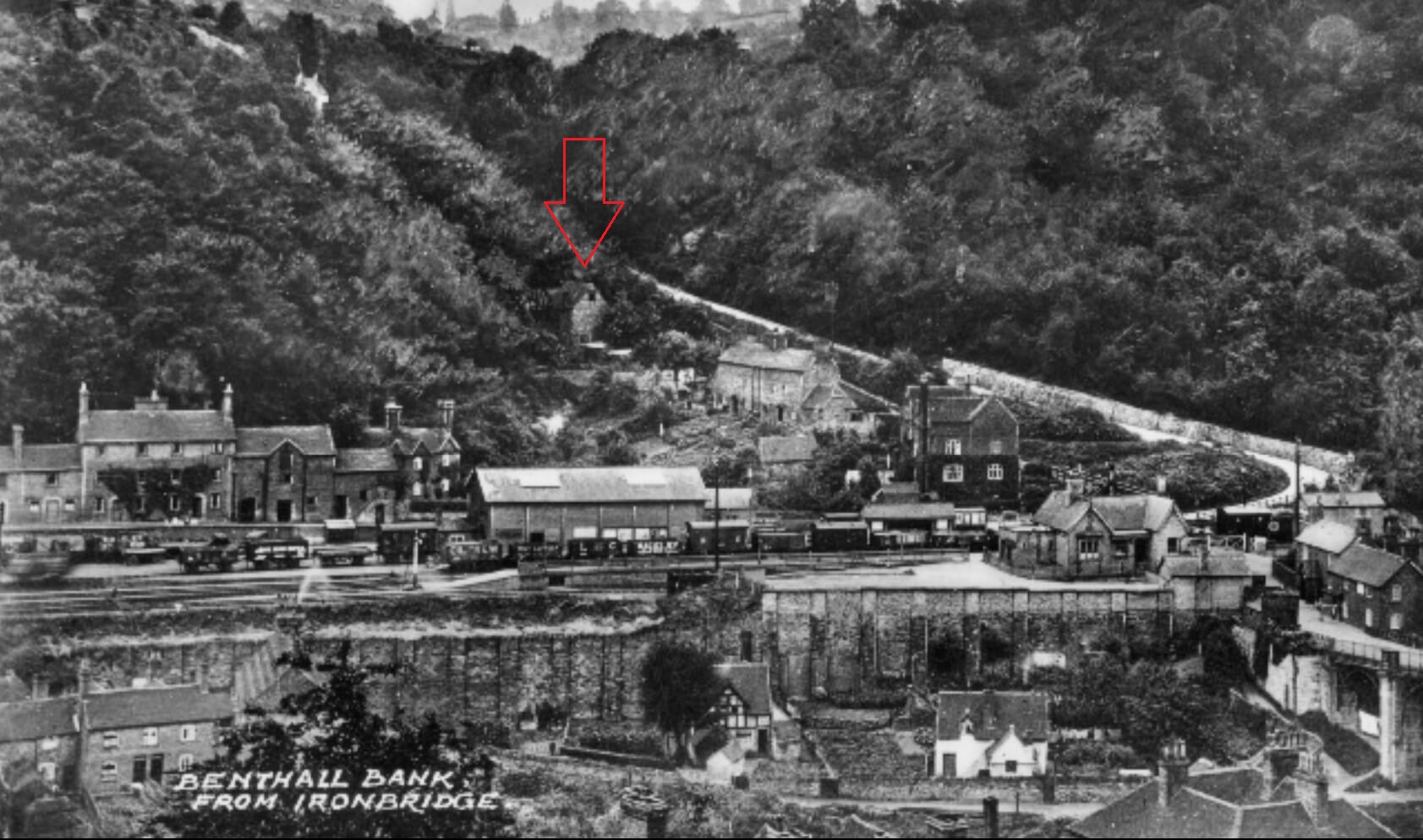 Benthall Bank from Ironbridge. The red arrow marks the site of the mill on the wooded hillside.