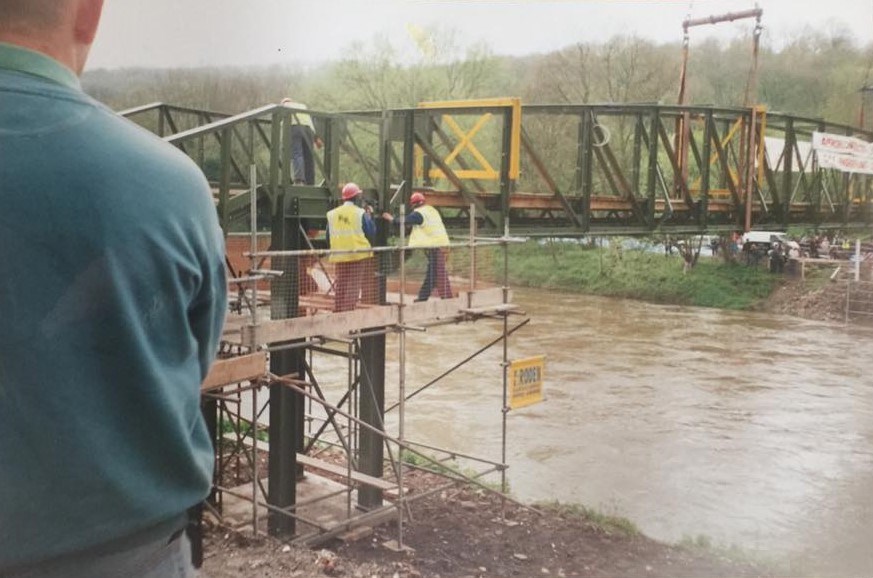 Spring 2000: contractors on the scaffolded staging at the Jackfield abutment as the refurbished span is guided into position above the flooded Severn.
