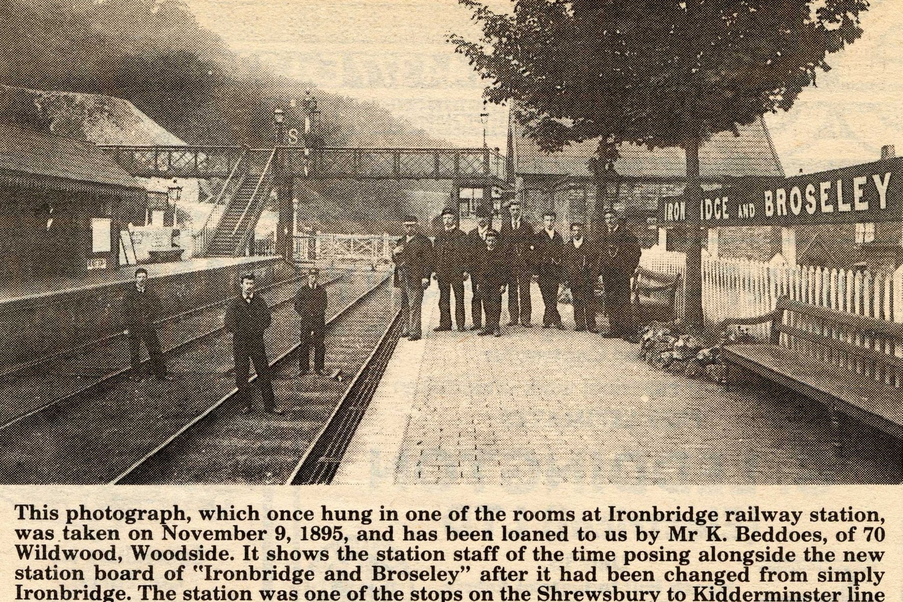 A newspaper cutting, reproduced from a photograph that once hung inside the station itself, shows staff posed proudly beside the brand-new “Ironbridge and Broseley” nameboard on 9 November 1895. The date marks the moment the station was renamed from plain “Ironbridge”, and the image preserves the faces of the men who actually ran it.