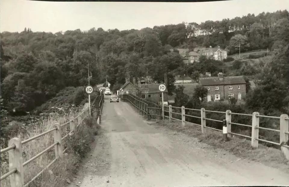 The Broseley approach, photographed in the mid-twentieth century, shows a 10 mph roundel posted at each end of the deck. Traffic control here has never relied on barriers or lights so much as on signs, faith and mutual courtesy between drivers meeting on a bridge built wide enough for one vehicle at a time.