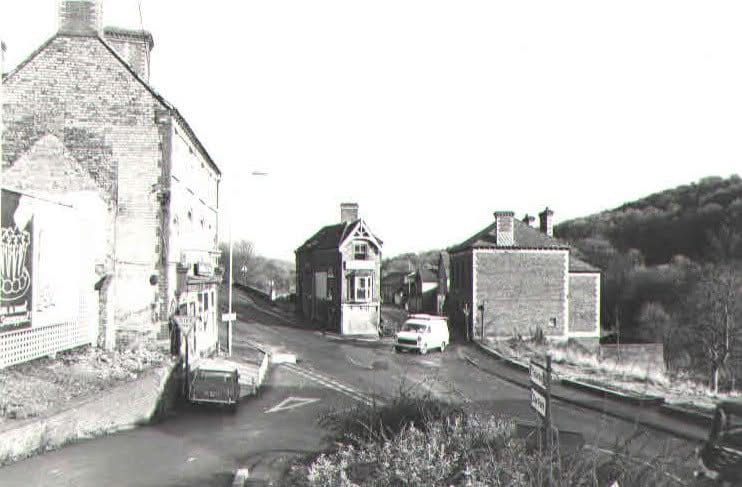 The junction after clearance, with the surviving corner building and road signs visible