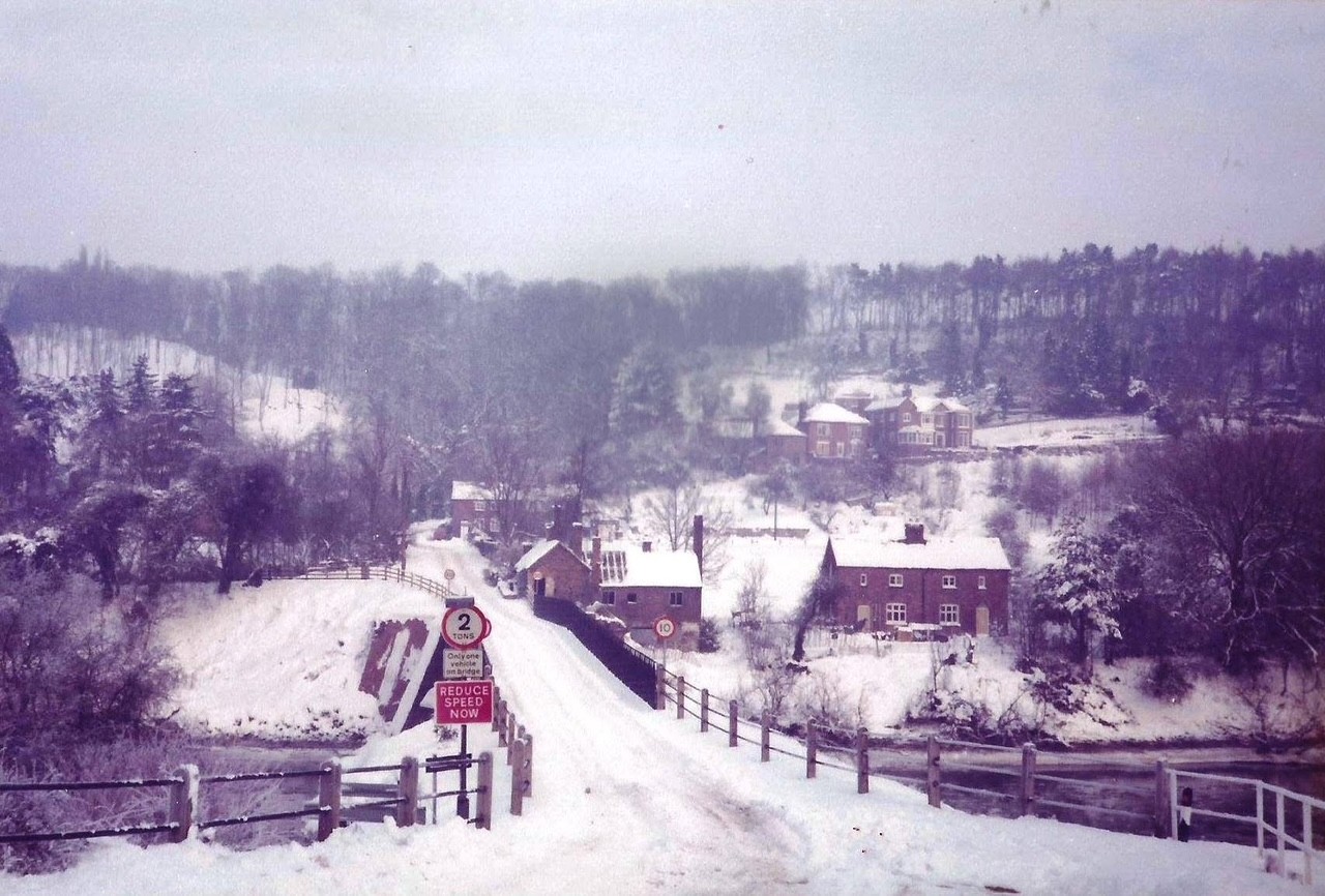 The approach under snow, twentieth century, weight and speed signs stacked together at the gate. Winter closes the wider Gorge road network quickly and often, and in those moments this narrow crossing has repeatedly proved the only way across the Severn for local traffic, snow or no snow.