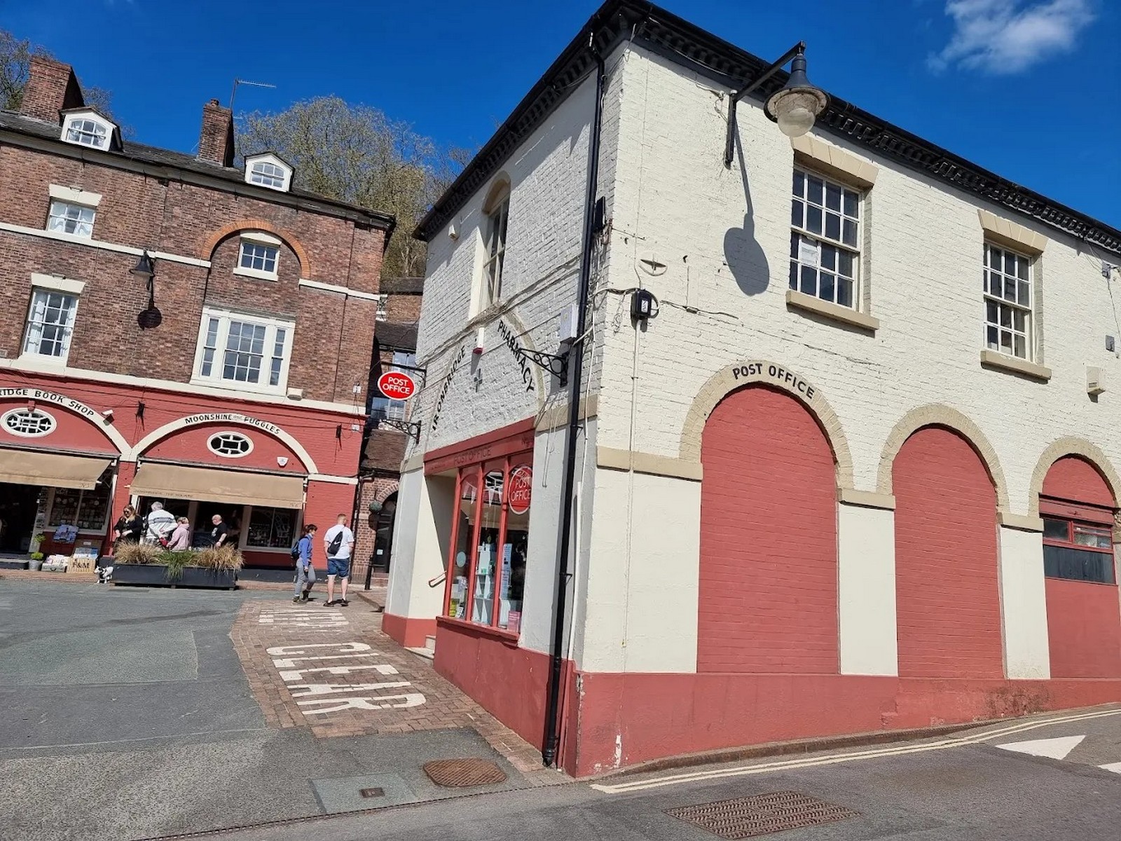 The corner building with the long arcaded range of the old Butter Market alongside it. Seen together like this, the two read as one structure again, which is exactly how the market worked: covered trading under the arches, open selling in the Square. Present day.