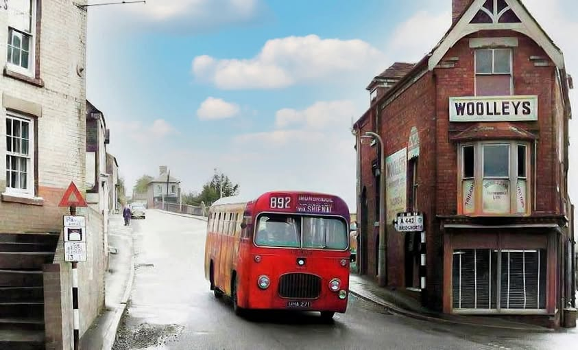 A bus at the foot of the hill beside Woolley's — the route number appears to read 892 — in a colourised view of the street