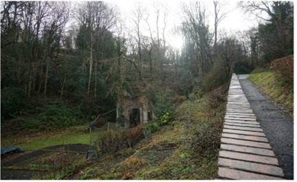 The surviving ruins of the mill among the trees on Benthall Bank today.