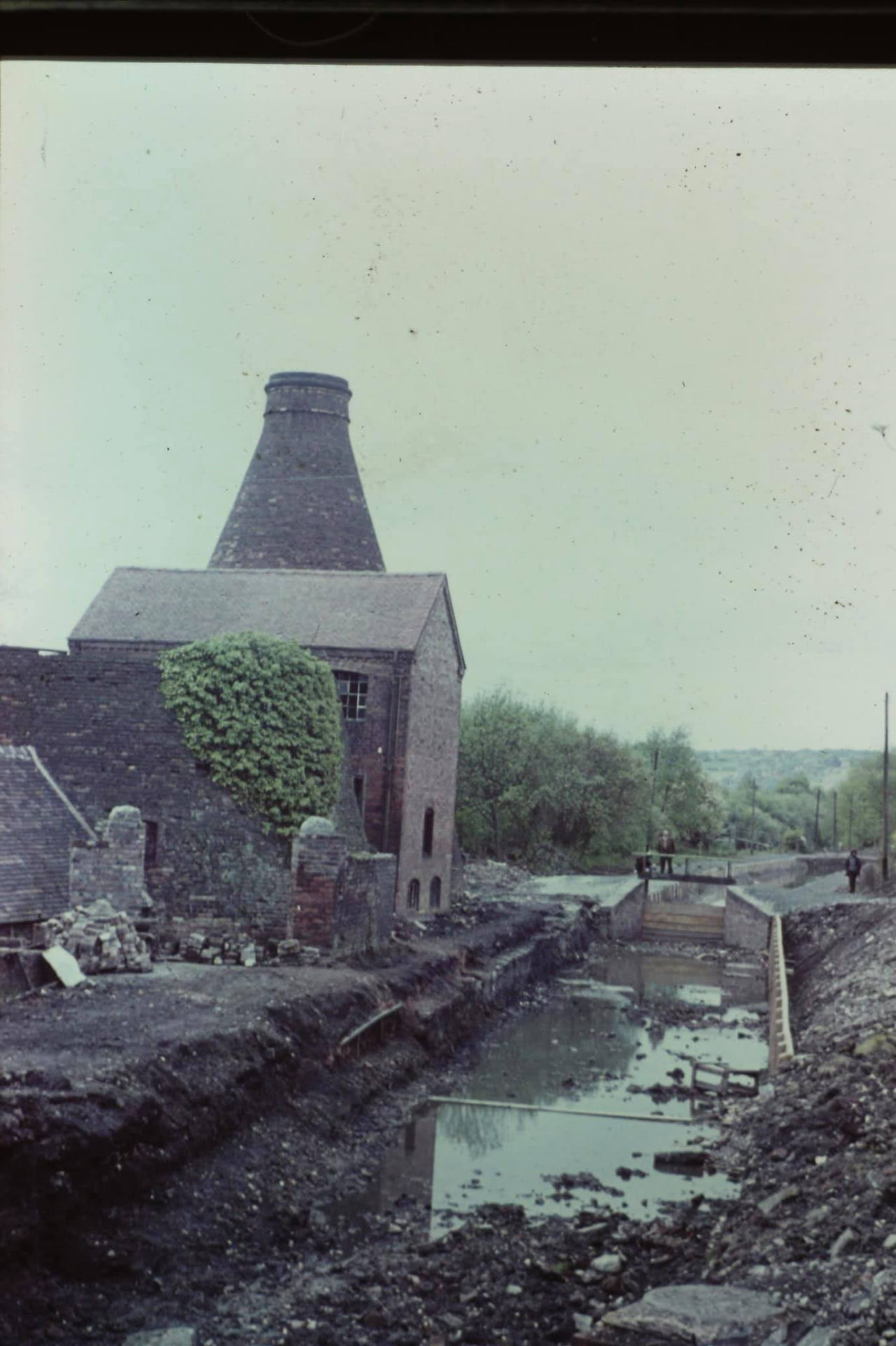 Restoration work beside a surviving bottle kiln