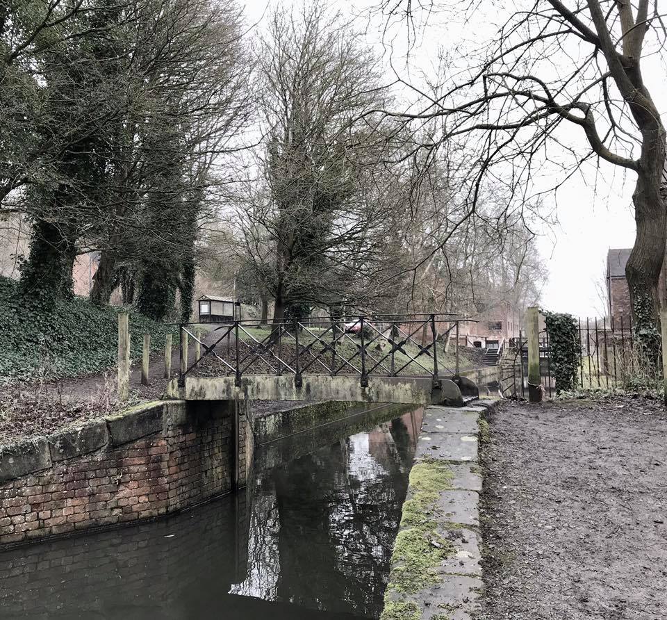 A narrow surviving section of the canal and its footbridge