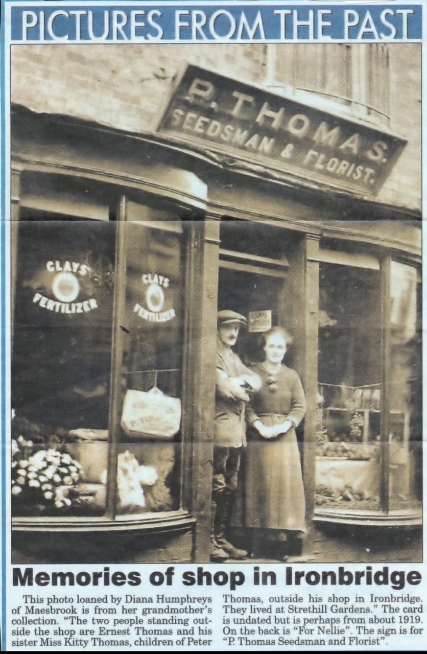 P. Thomas, Seedsman & Florist. Ernest Thomas and his sister Miss Kitty Thomas stand outside the shop; the card is undated but is perhaps from about 1919.