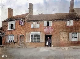 The Robin Hood in earlier days, the landlord standing in the doorway. Colourised.