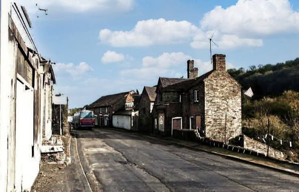 Half the street already down, the surviving houses left standing
