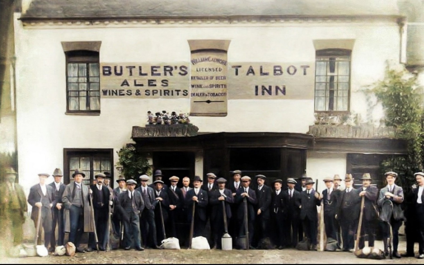 The same frontage under Butler's Ales, licensee William Cadwallader named on the centre board. Supplied as a colourised copy of the original photograph.