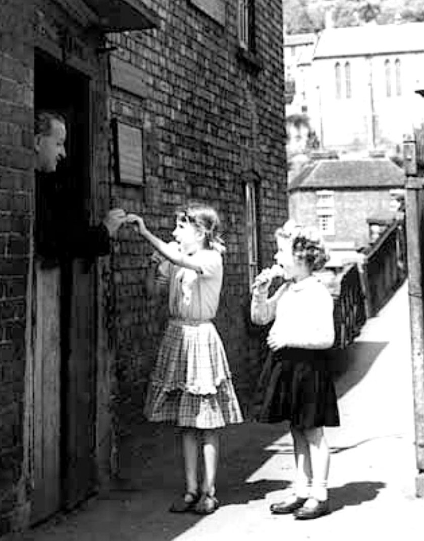 Two girls paying their halfpenny toll shortly before charges ended in 1950.