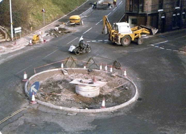 The new traffic island being built at the top of Waterloo Street, with a digger, cones and a motorcyclist passing