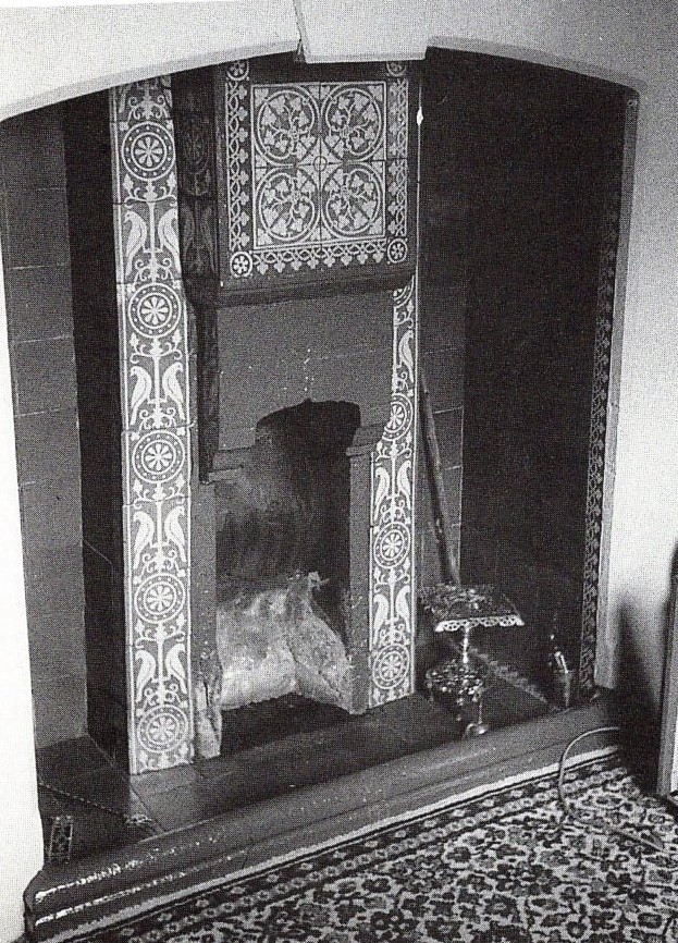 A tiled fireplace surround of the kind Maws made for ordinary front rooms
