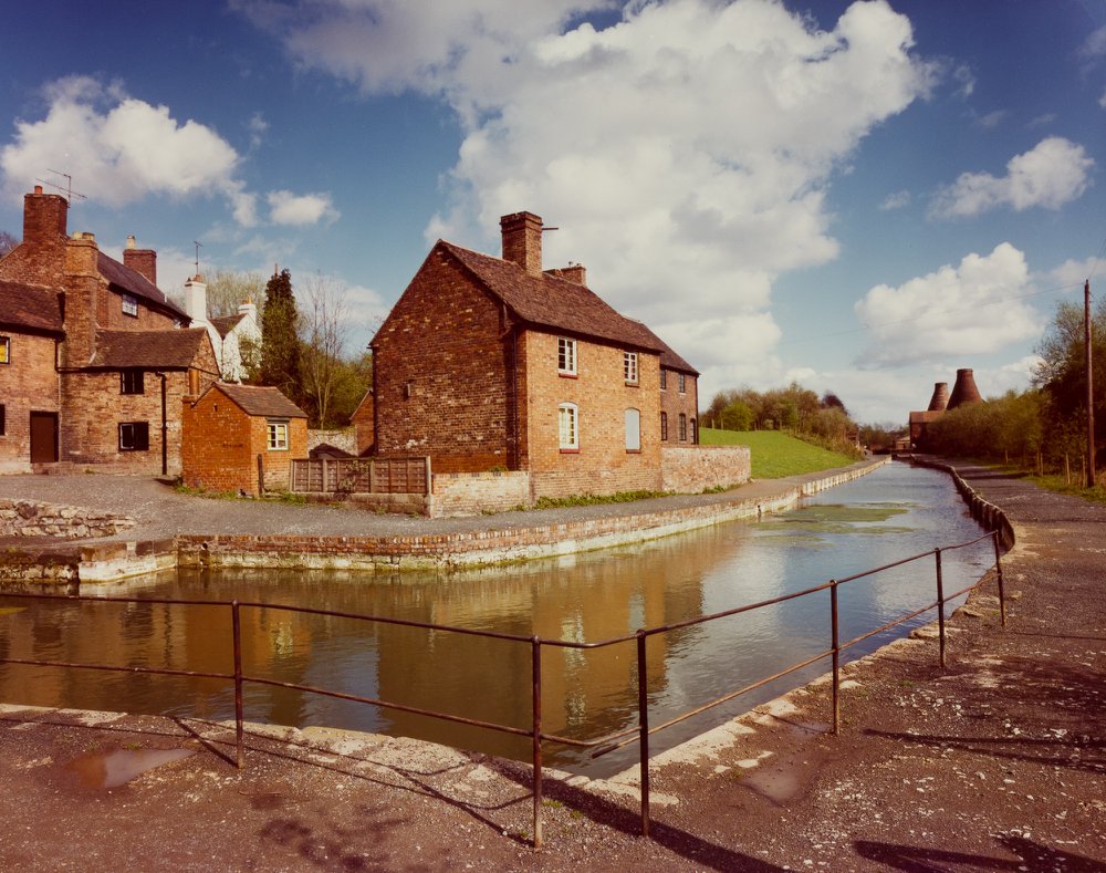 The re-watered canal reflecting the canalside cottages