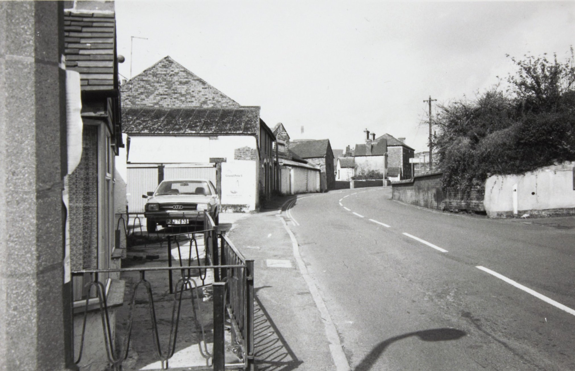 Waterloo Street, with the walled and overgrown ground between the street and the river