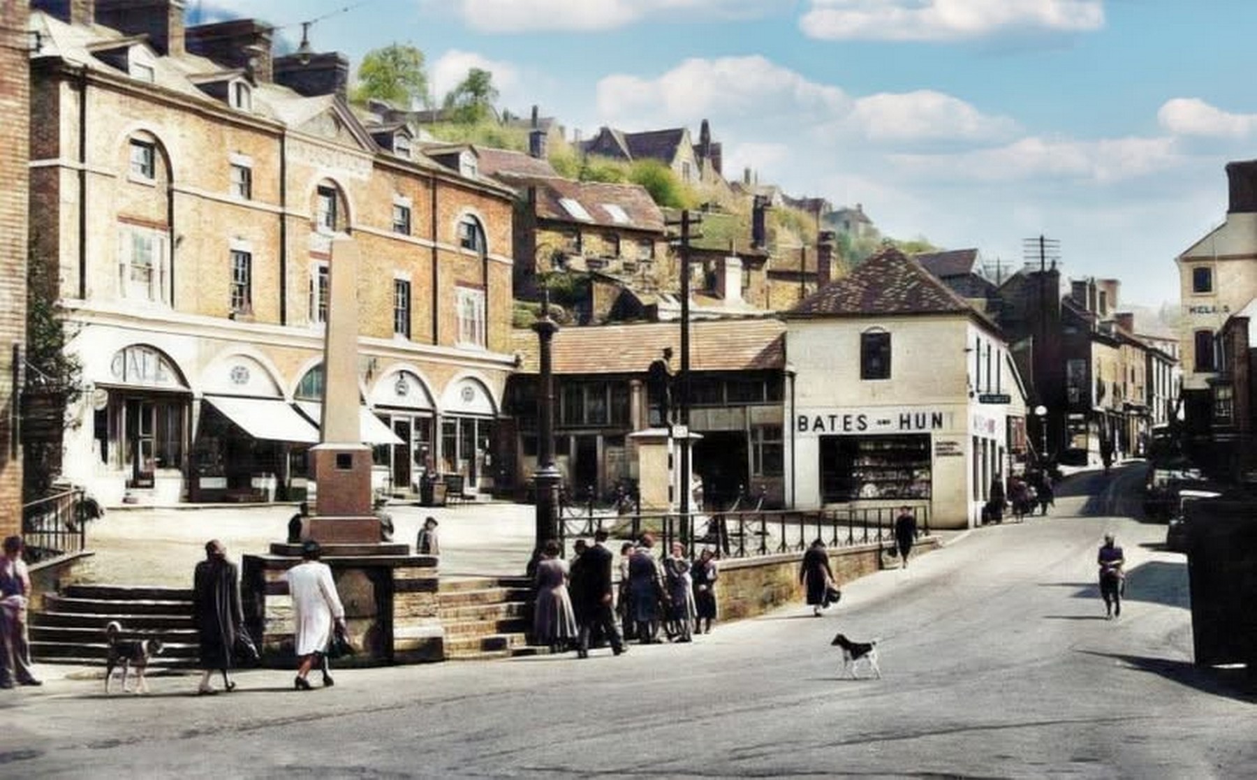 The Square with Bates & Hunt, chemists, and the arcaded market building running away beyond. The chemist's window display is worth a second look — patent medicines were sold here long before the National Health Service reached the Gorge. Exact date unknown.