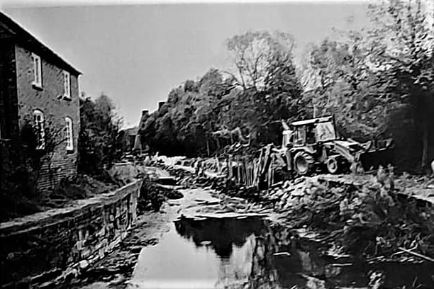 A digger at work restoring the canal channel