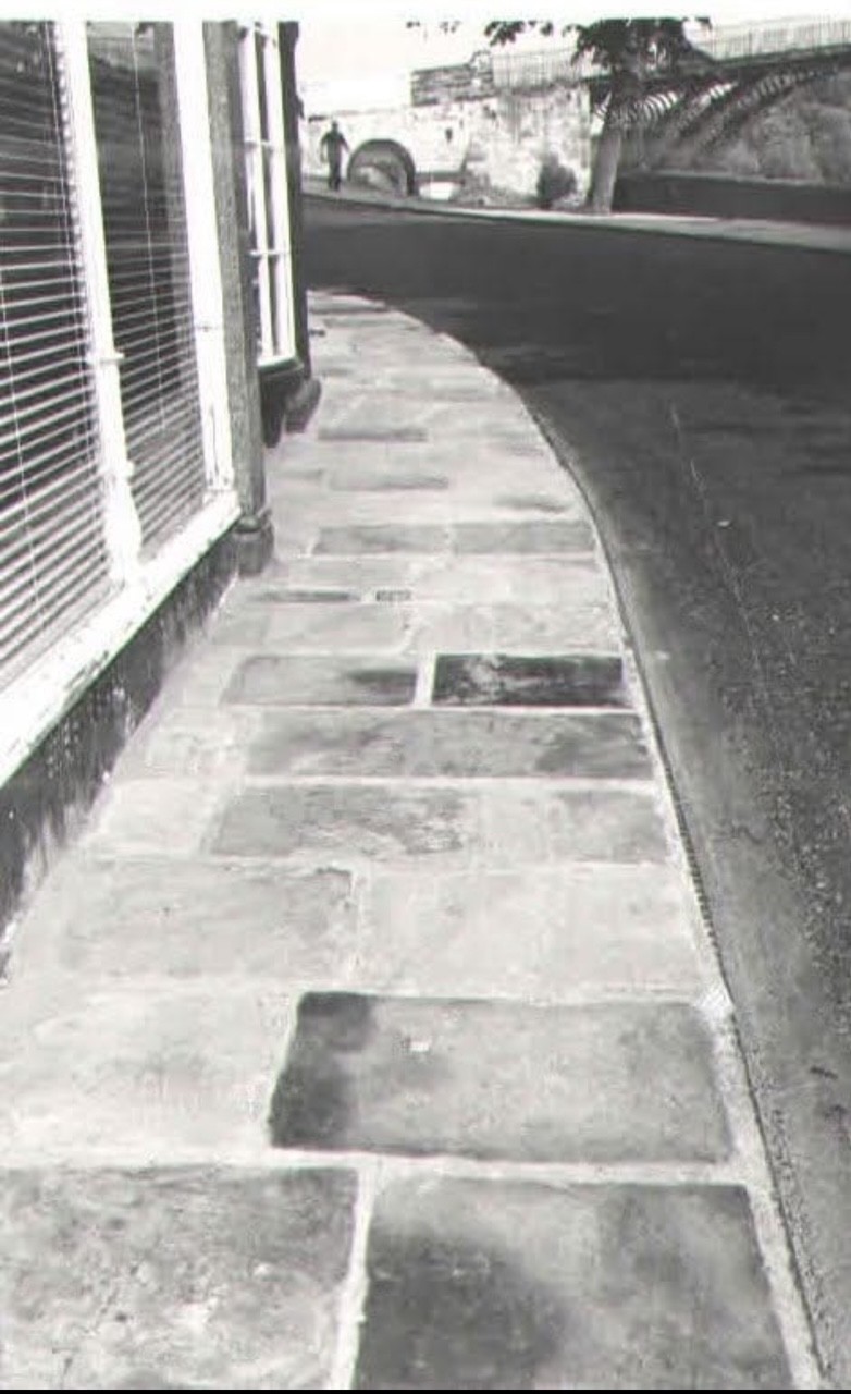 The new stone pavement curving beside the road