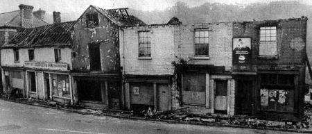 A gutted row of shops, roofs off, awaiting clearance