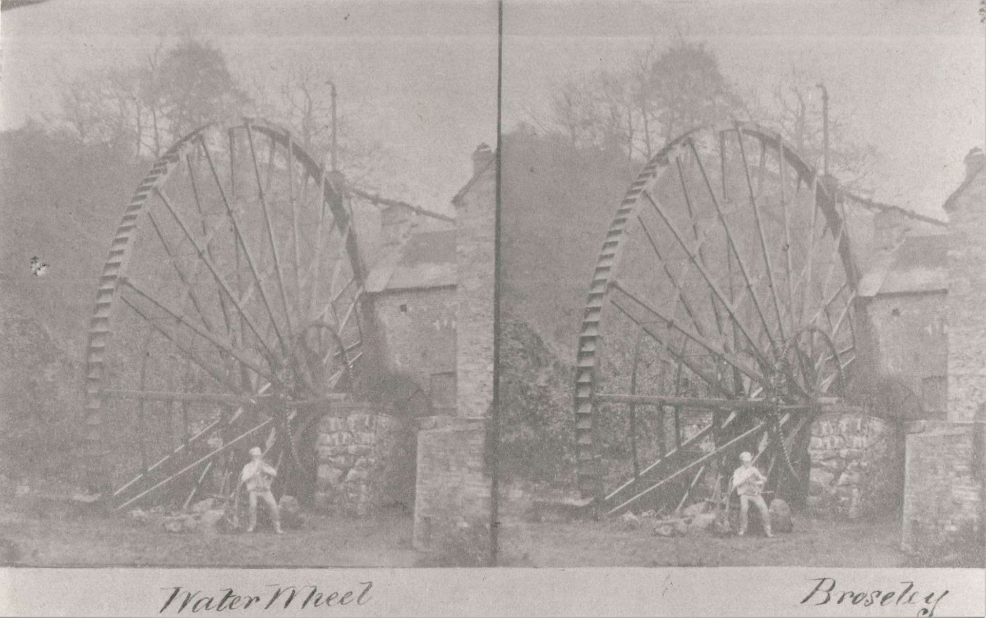 A stereoscopic card titled "Water Wheel, Broseley". The figure standing beneath the wheel shows how big it was.